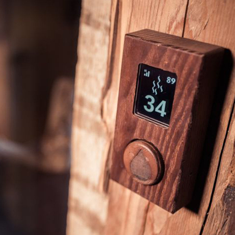 HUUM UKU thermo-ash wood control panel mounted on a sauna wall