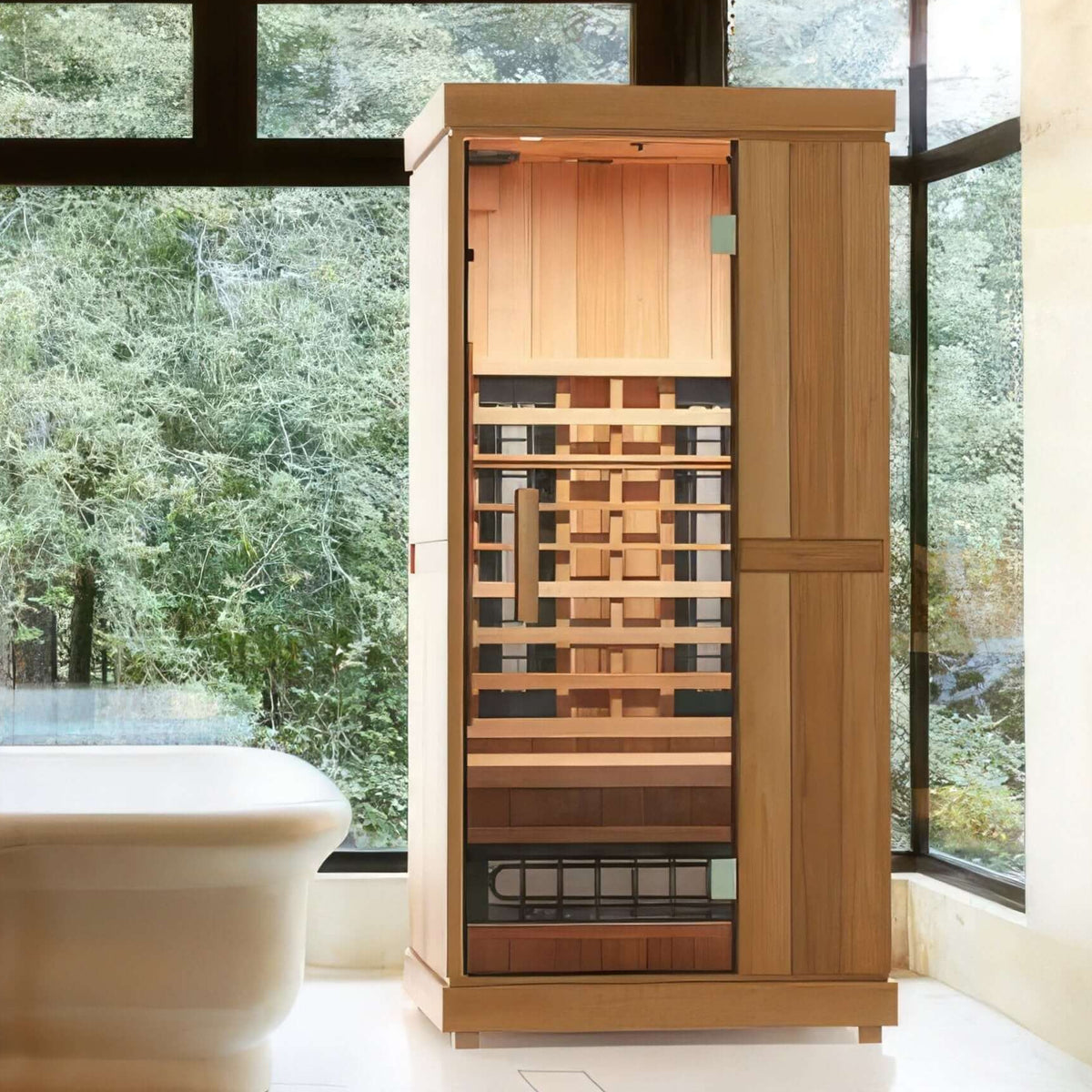 Finnmark FD-1 one person full spectrum infrared sauna lit in a room with floor to ceiling windows onto woodland