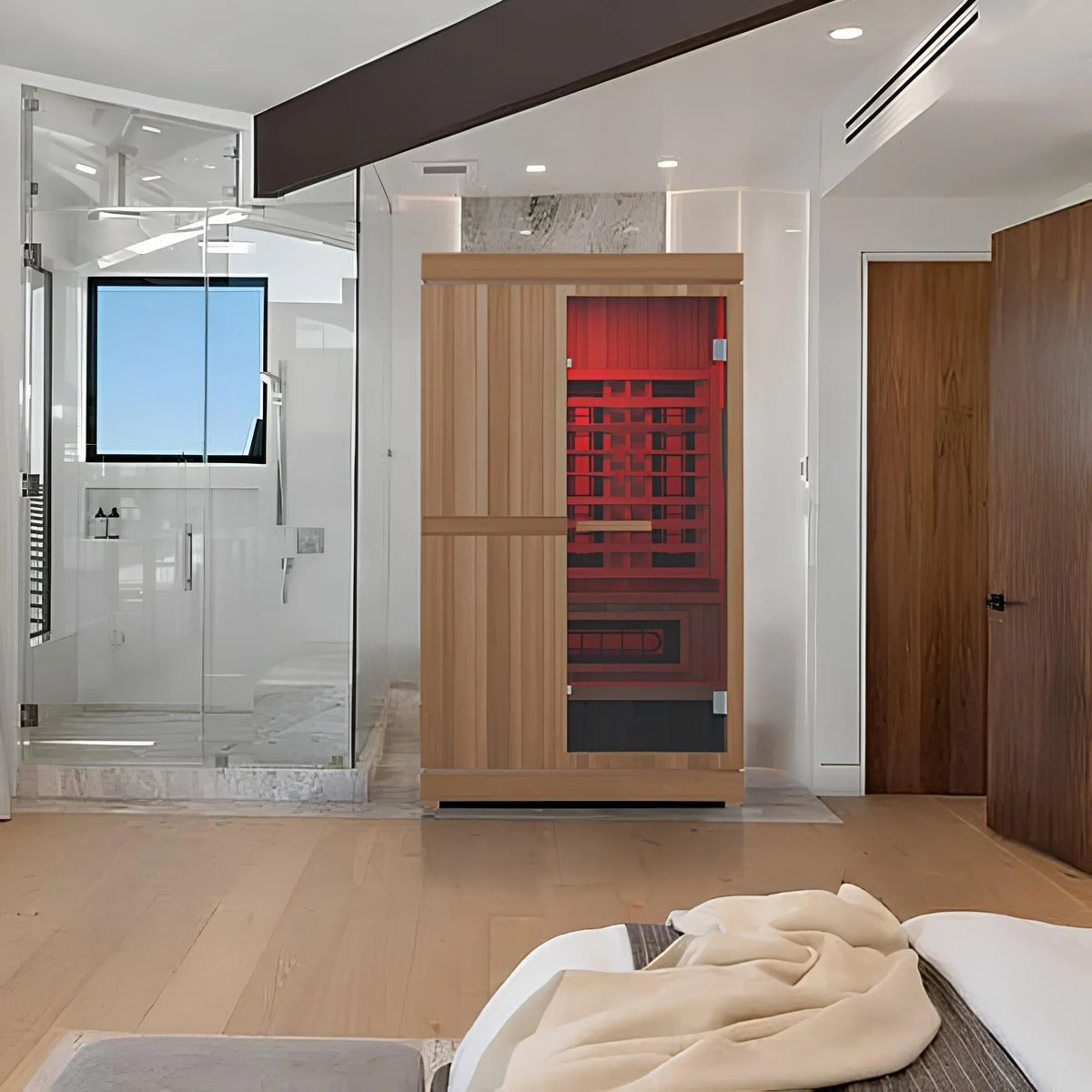 Finnmark FD-4 Trinity sauna in a bedroom, interior lit red through the glass door