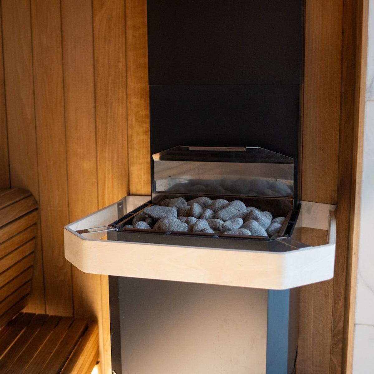 Saunum Air safety rail fitted around the stone basket of a Saunum Air heater in a sauna
