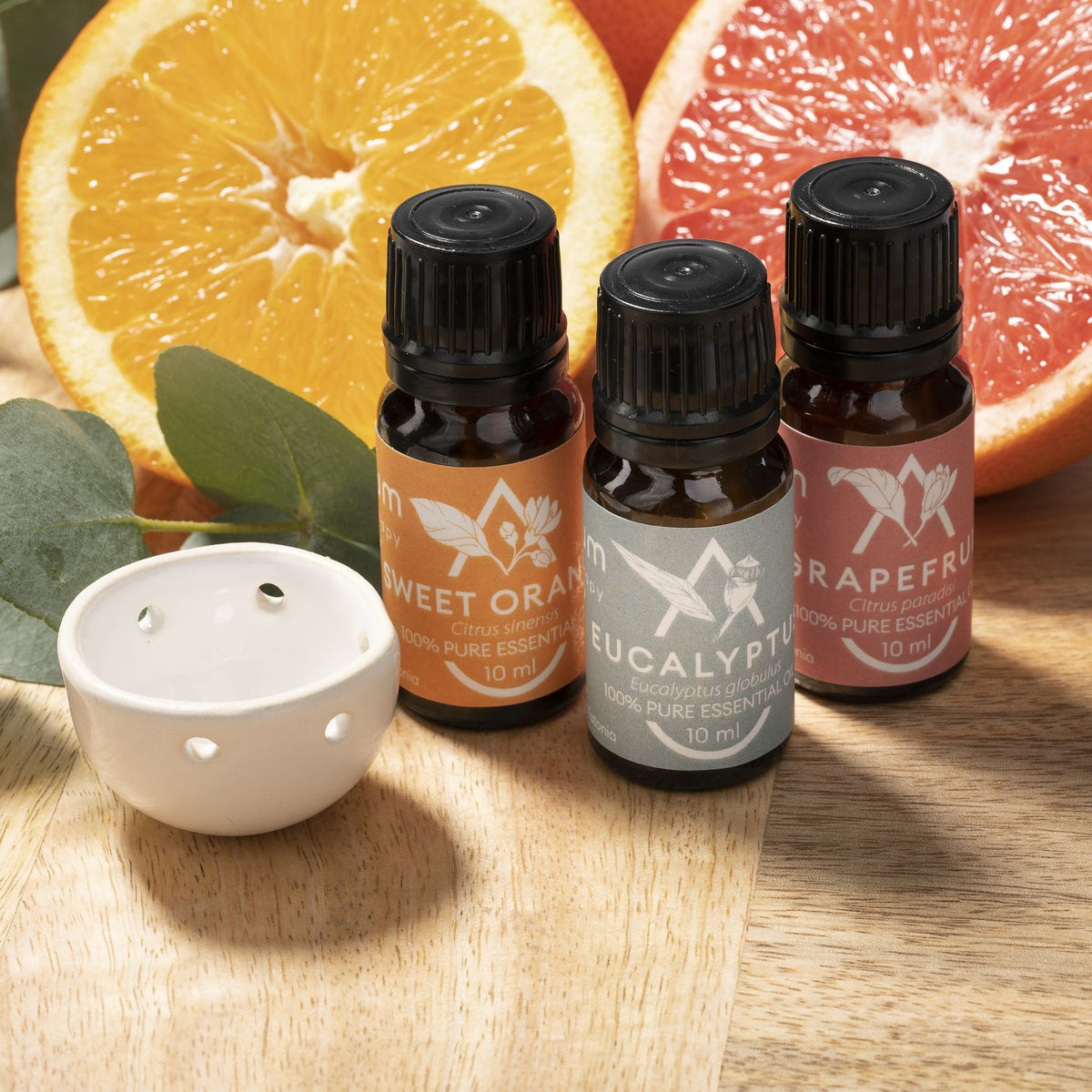 Saunum eucalyptus, grapefruit and sweet orange sauna oil bottles with the ceramic aroma bowl