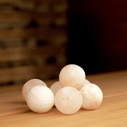 Saunum Himalayan salt spheres on a wooden sauna bench
