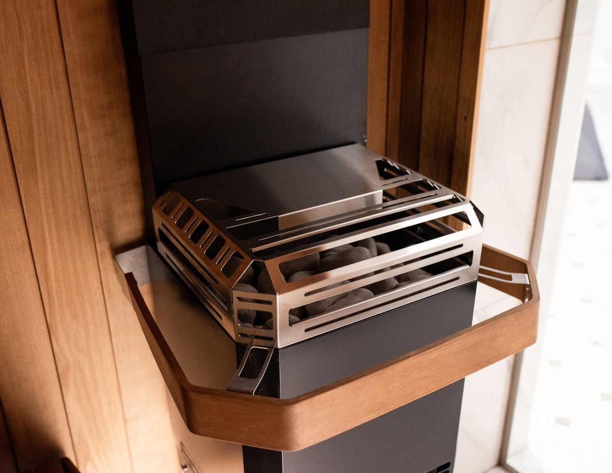 Saunum Air L 13 closed black steel basket in a sauna, shown with the optional Air L Safety Rail
