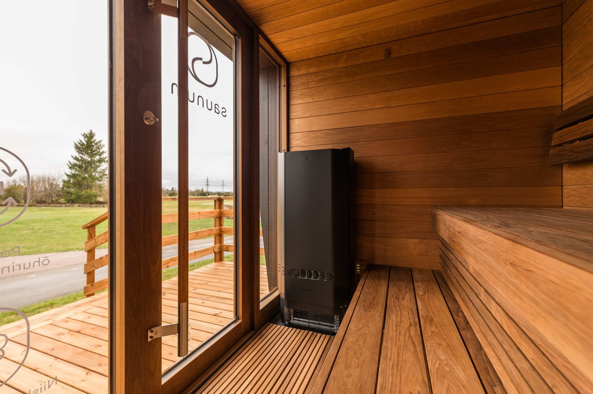 Saunum Air Perfect 10 heater from the package in a wood sauna beside a glass door