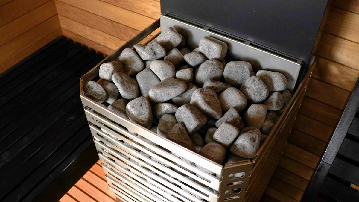 Saunum Air L 15 open stainless steel basket filled with sauna stones, three quarter view from above