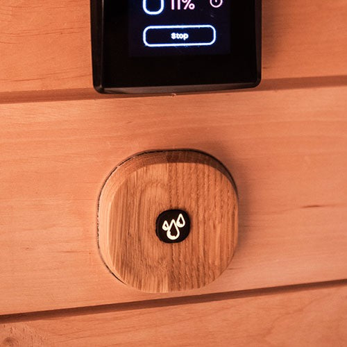 Saunum AutoLeil wall button with the water drop symbol in a wood sauna