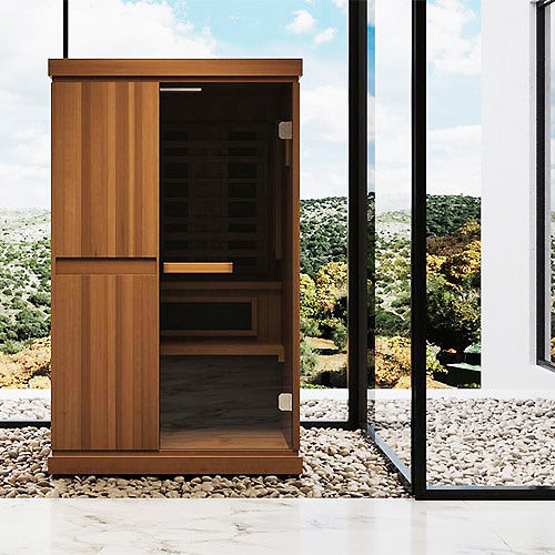 Finnmark FD-4 Trinity sauna standing in a room with a window and a gravel border