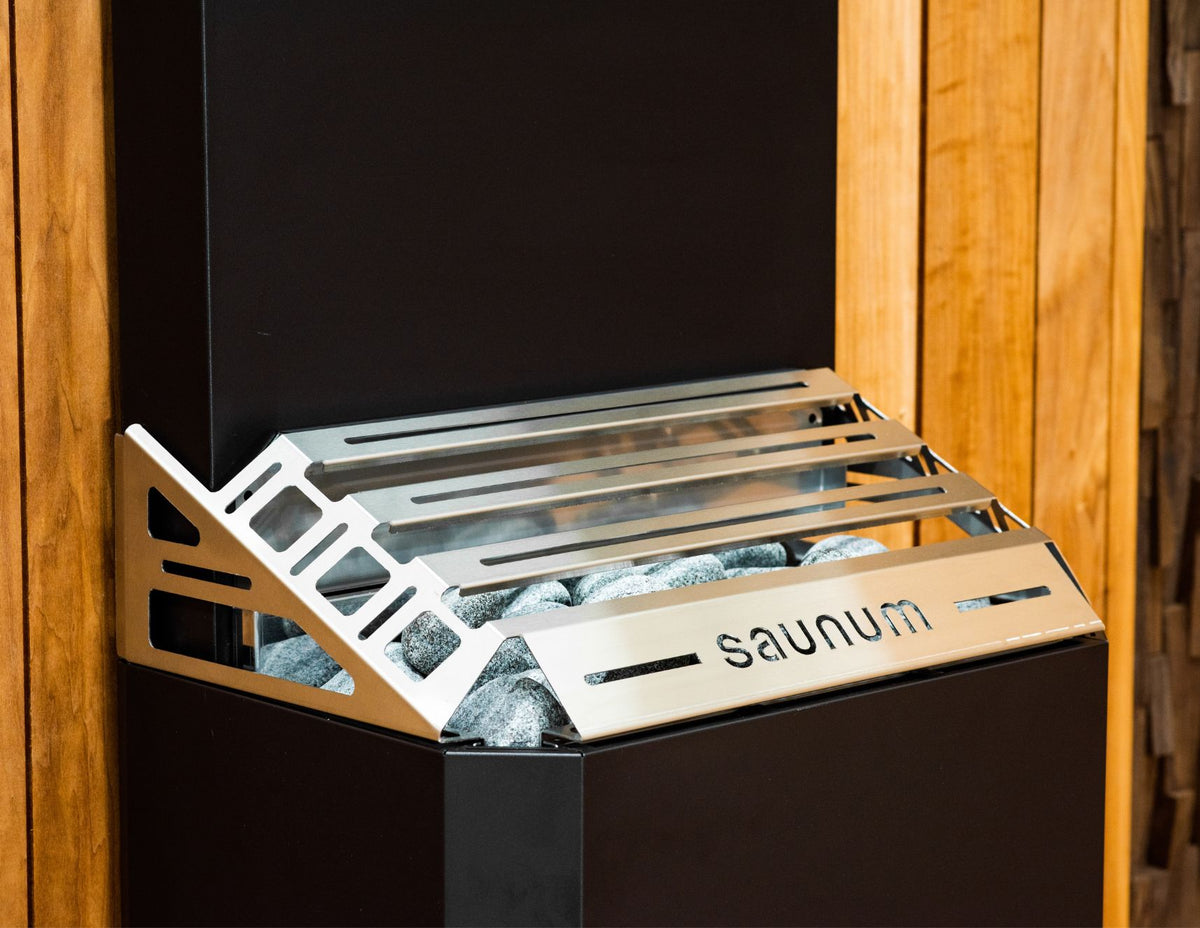 Close-up of the Saunum Air 7 closed basket slatted steel top with the Saunum wordmark
