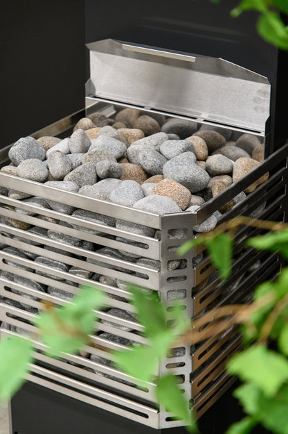 Close-up of the Saunum Air L 10 open stainless steel basket loaded with sauna stones