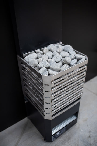 Saunum Air L 15 open stainless steel basket full of stones, three quarter view
