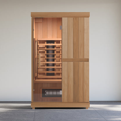 Finnmark FD-2 infrared sauna standing against the wall of a glazed sunroom with a tiled floor