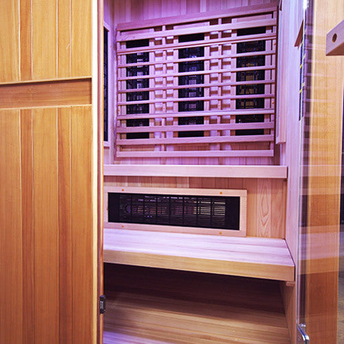Side view inside the Finnmark FD-4 Trinity sauna showing the bench, the wall panels and the glass door