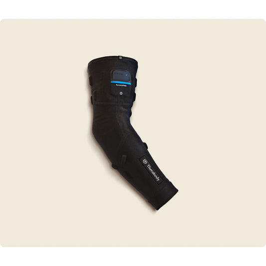 Therabody RecoveryPulse Arm worn on arm — lifestyle recovery use