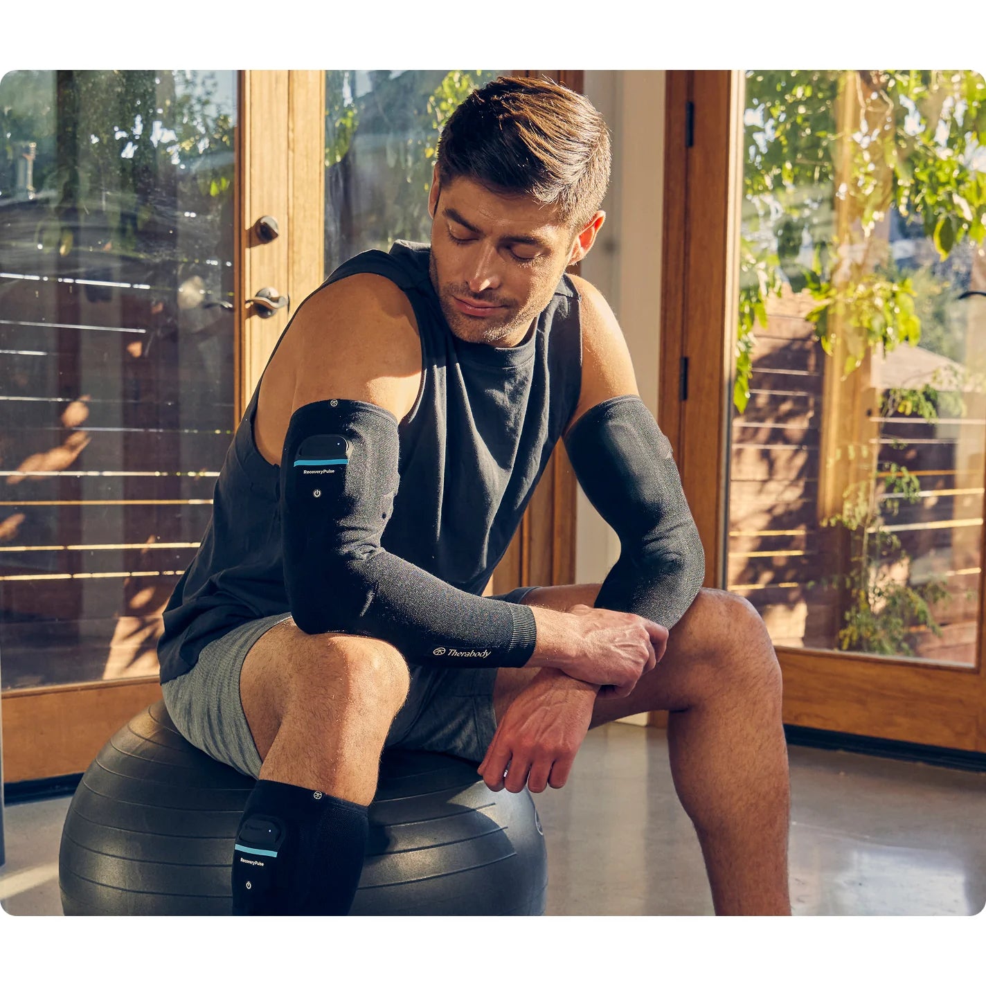 Therabody RecoveryPulse Arm — portable wearable compression sleeve in active use