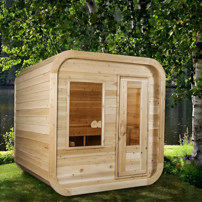 Canadian Timber CT Luna 4 person outdoor cube sauna in white cedar, beside birch trees at the water's edge