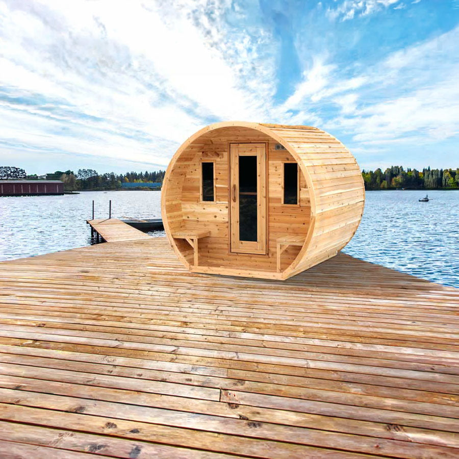Canadian Timber CT Elation 4 person outdoor barrel sauna on a wooden lakeside dock, front on, with the door, two front windows and two outside benches