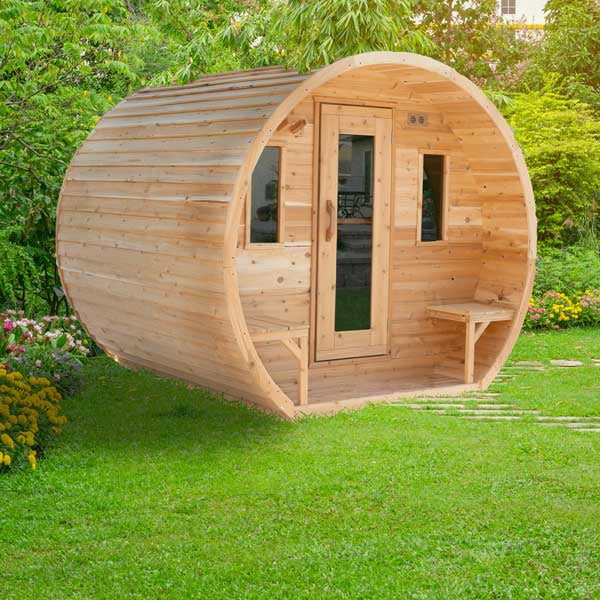 CT Elation white cedar barrel sauna on a lawn, three-quarter view of the bevel siding and window wall