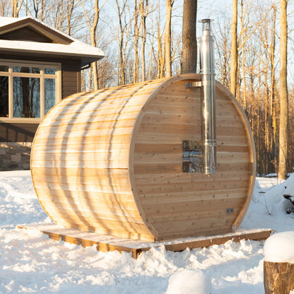 Wood-fired CT Elation sauna in snow with the stainless chimney exiting through the barrel wall