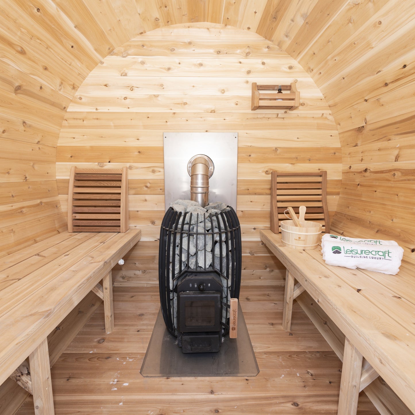 Interior of the CT Elation sauna looking straight at the wood-burning stove between the two 23-inch benches on the flat cedar floor