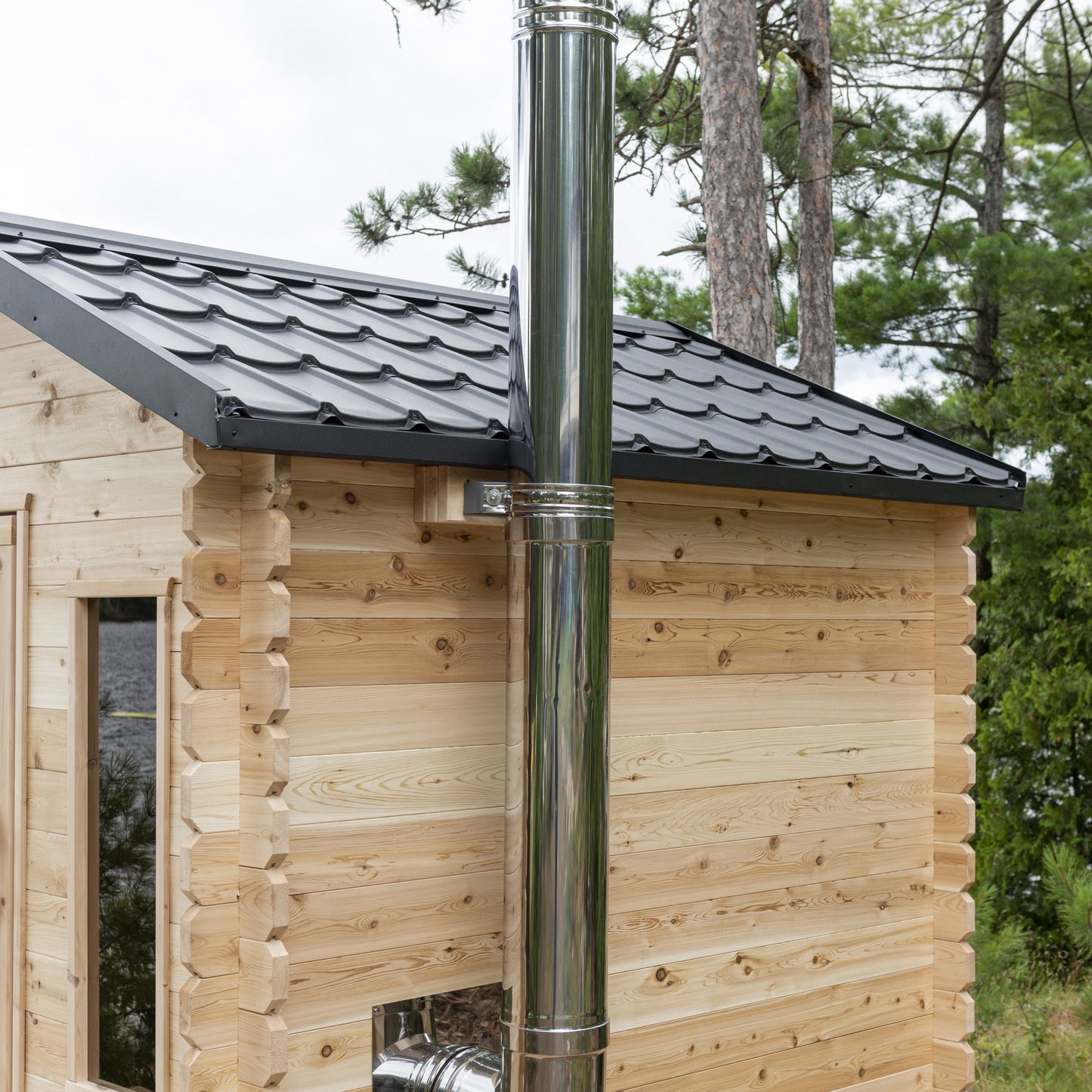 Side of the CT Georgian cabin sauna with the stainless chimney and metal shingle roof
