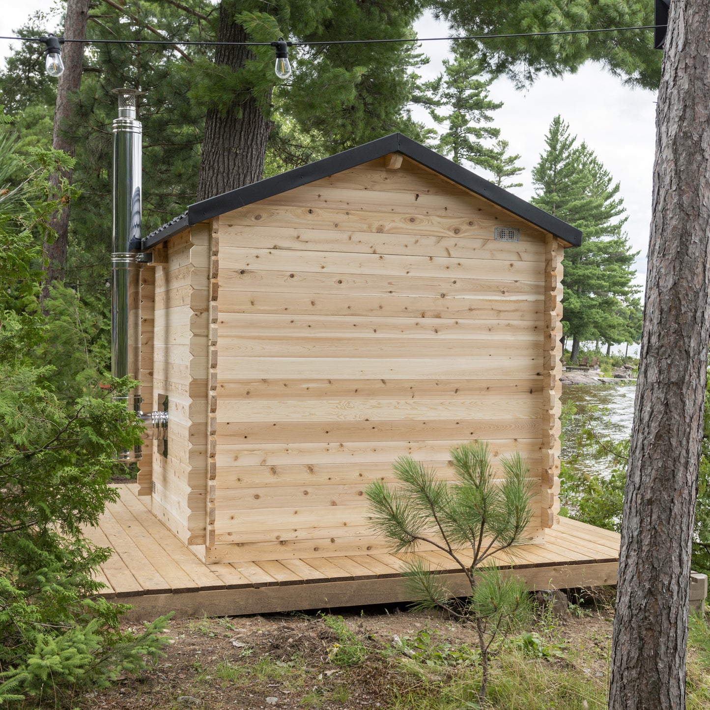 Rear of the CT Georgian cabin sauna on its platform among the pines