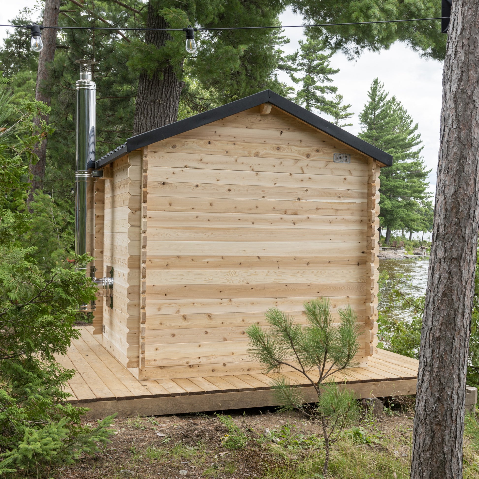 Rear of the CT Georgian cabin sauna on its platform among the pines