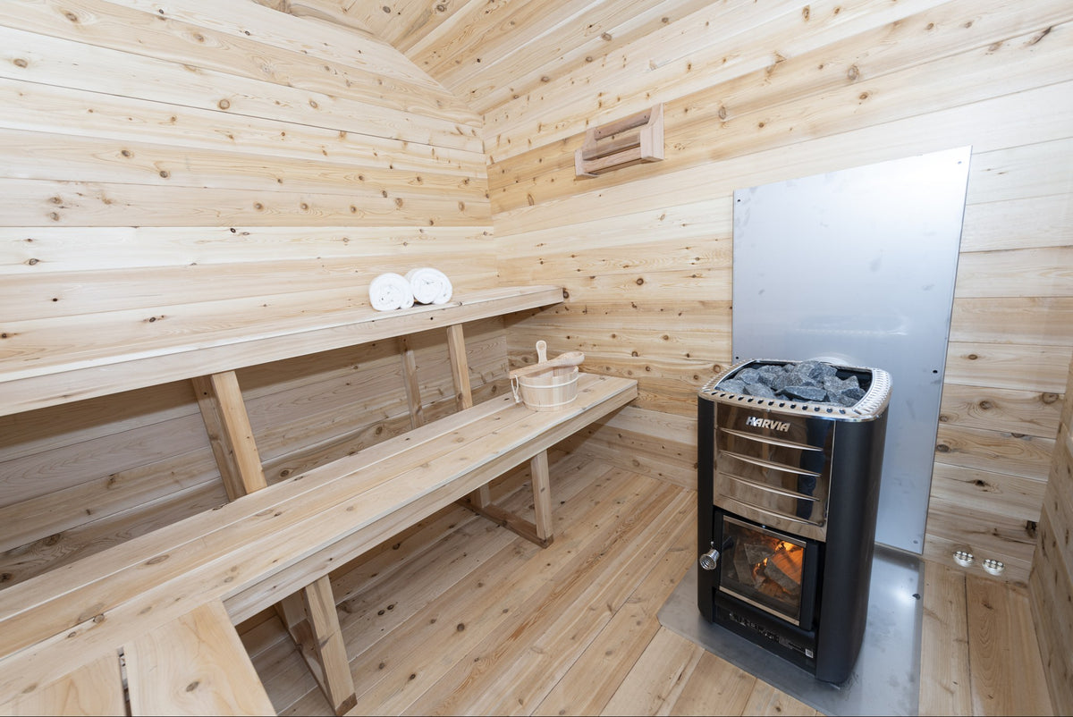CT Georgian interior with the two-tier cedar benches and a Harvia wood stove behind its heat shield