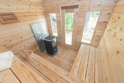 Wide view of the CT Georgian cabin sauna interior with windows, benches and heater