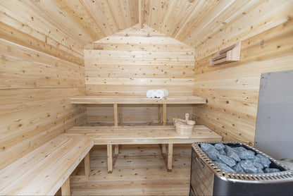 Electric heater inside its cedar guard beside the bench in the CT Georgian cabin sauna