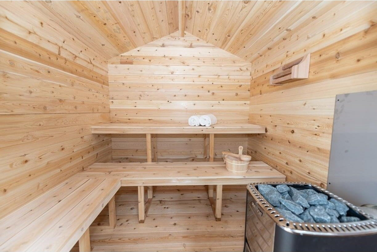 Electric heater inside its cedar guard beside the bench in the CT Georgian cabin sauna