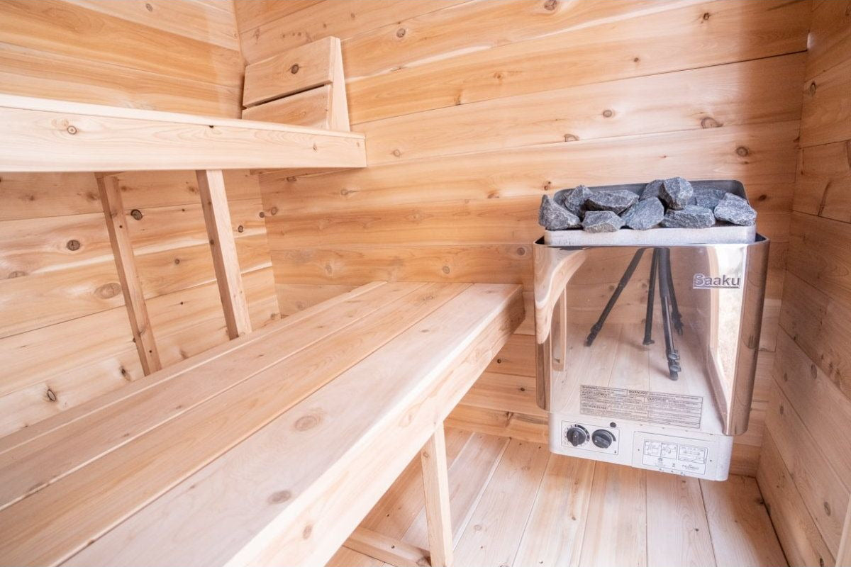 Electric heater with rocks mounted inside the CT Granby cabin sauna