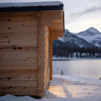 CT Palmer cabin sauna corner on a snowy lakeshore with mountains behind