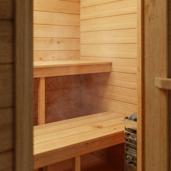 Two cedar bench tiers and the electric heater inside the CT Palmer cabin sauna