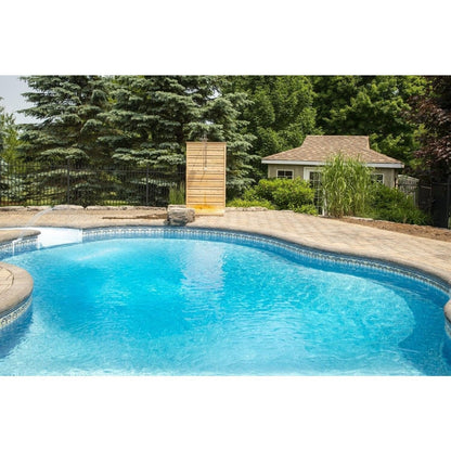 Wide view across a backyard pool to the CT Savannah panel on the far patio, the shower hardware shown is sold separately.