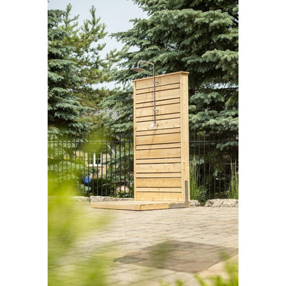 CT Savannah panel standing on its pad on a paver patio, spruce and a black fence behind, shower hardware sold separately.