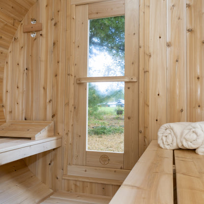 Inside the CT Serenity looking along the cedar bench toward the glazed front, with towels