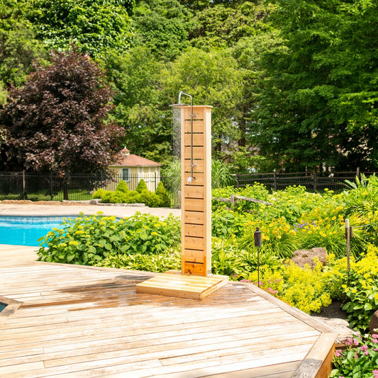 The CT Sierra Outdoor Shower pillar on its pad by a backyard pool, round rain head running, the shower hardware is sold separately.