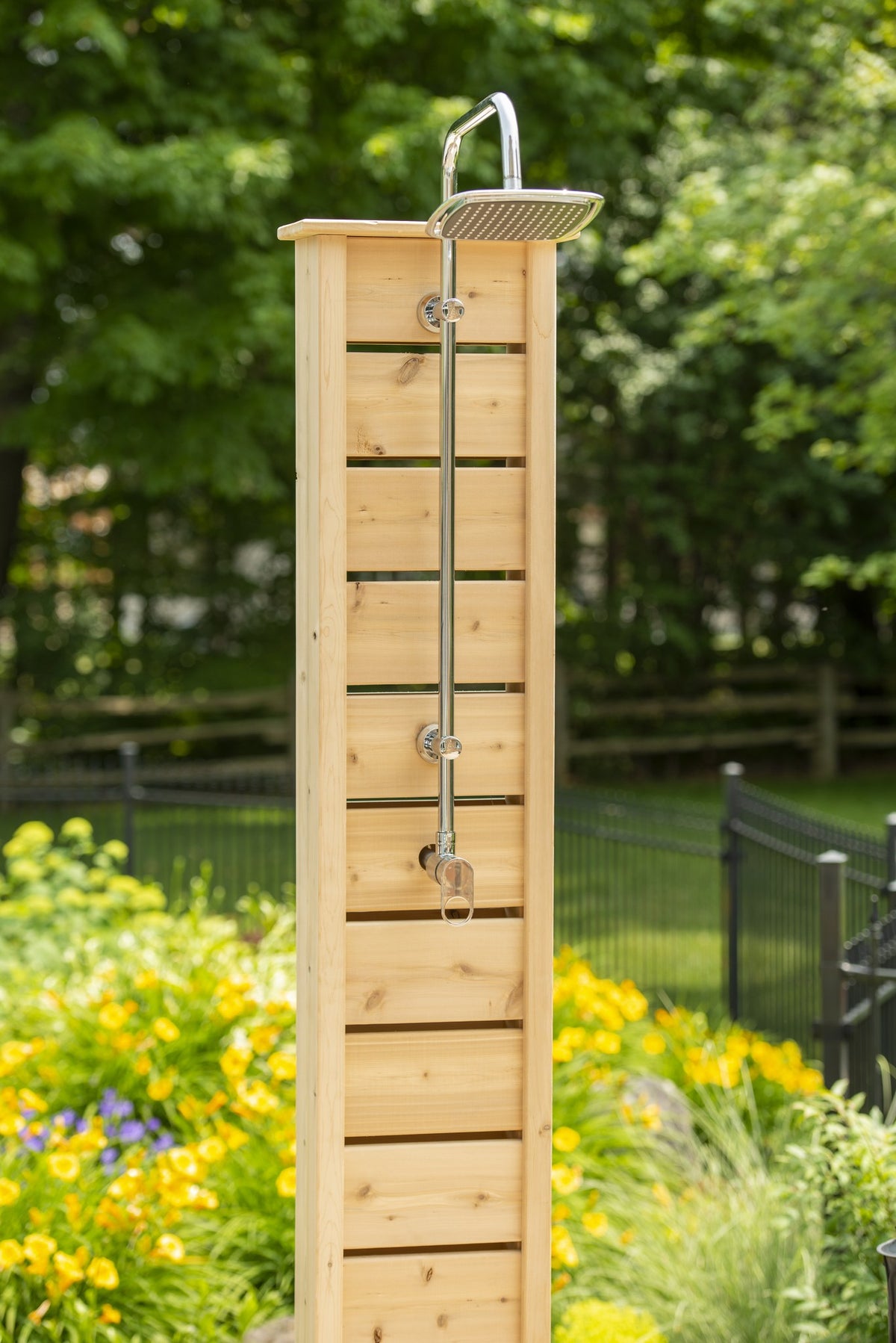Upper part of the Sierra pillar among garden plantings, square rain head and lever valve fitted, both sold separately, base out of frame.
