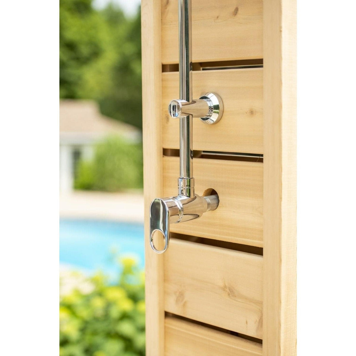Single chrome lever valve and riser flange on the slatted cedar face of the Sierra pillar, a pool behind, sold separately.
