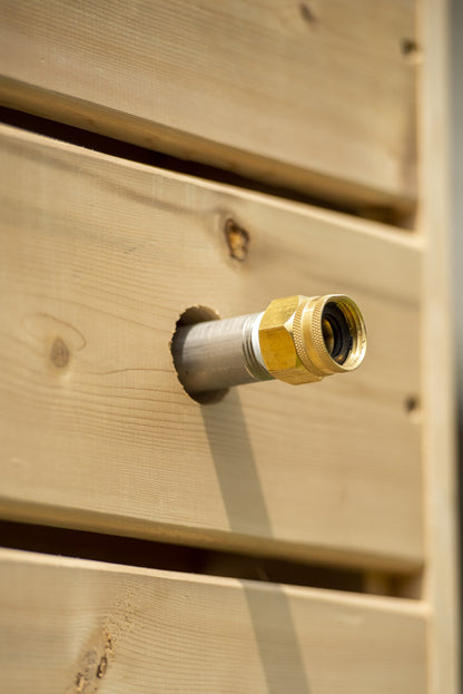 Brass garden hose thread fitting through a cedar board of the Sierra pillar, part of the hose connect kit sold separately.