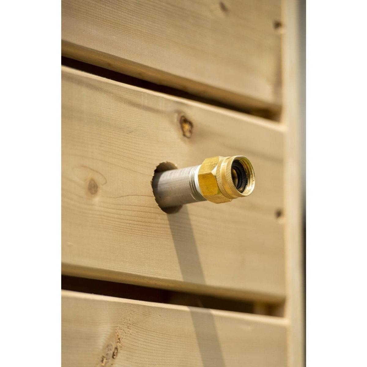 Brass garden hose thread fitting through a cedar board of the Sierra pillar, part of the hose connect kit sold separately.