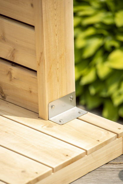 Stainless angle bracket fixing the Sierra shower pillar to its cedar floorboard base pad