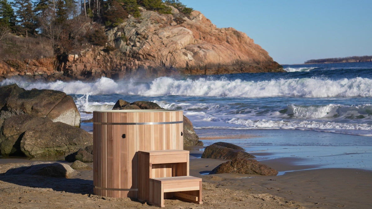 DCT Pacific Cedar Barrel cold plunge with cedar step, on a beach