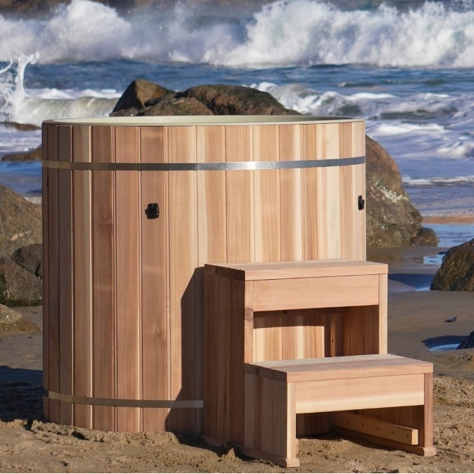 Dynamic Cold Therapy Pacific Cedar barrel cold plunge, plastic interior, with cedar step on a beach