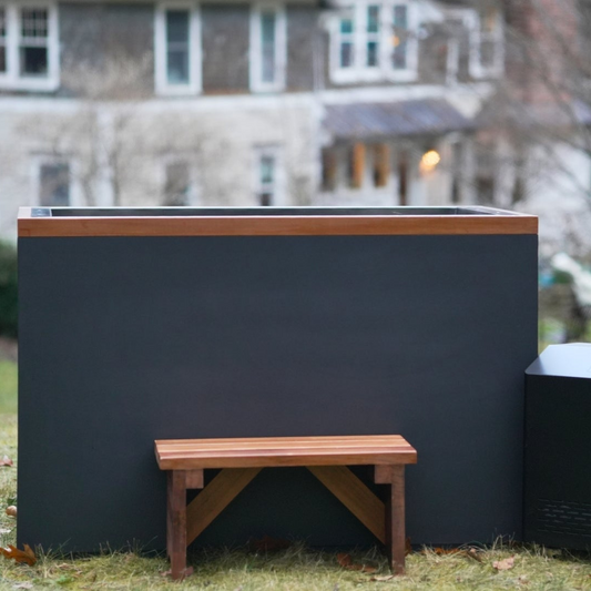 Dynamic Cold Therapy Cuboid plastic cold plunge with cedar bench and chiller on a lawn