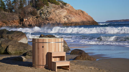 DCT Pacific Cedar Barrel cold plunge with cedar step, on a beach