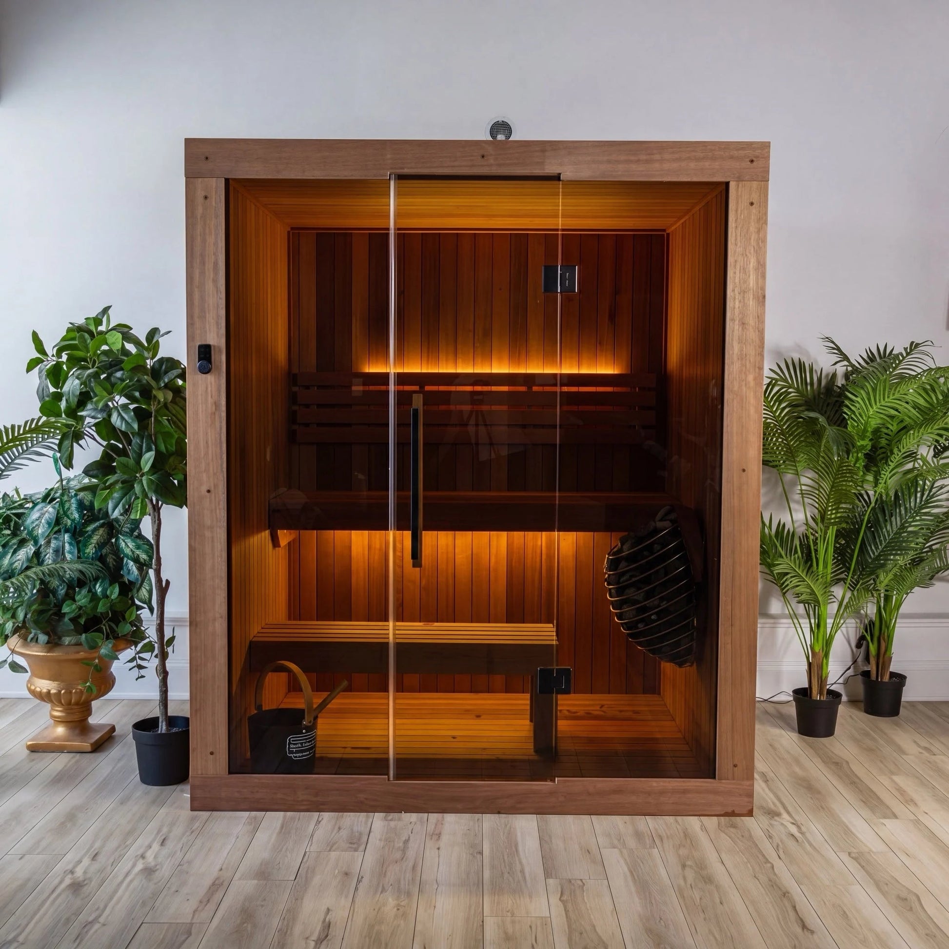 CT Element Loft indoor sauna, front elevation with glass doors closed and the interior lit