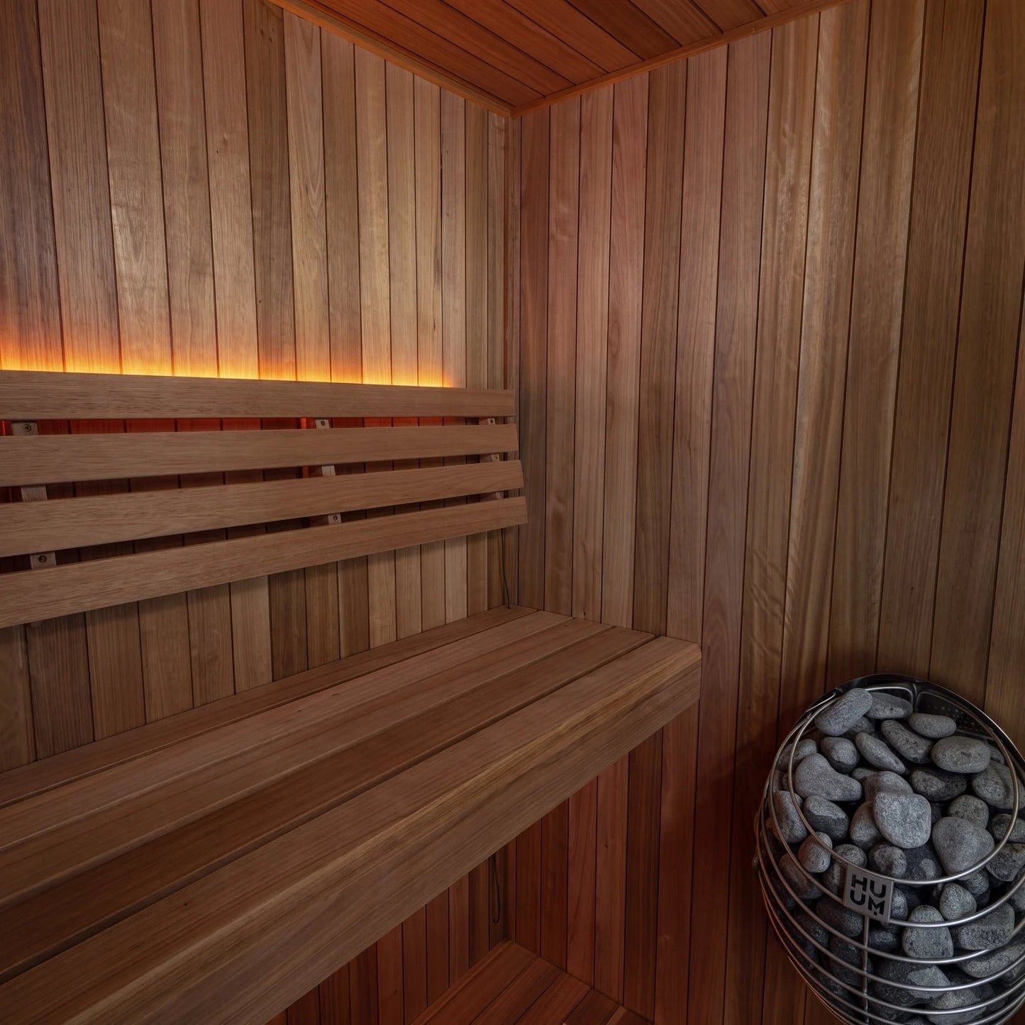 Interior corner of the CT Element Loft: upper and lower benches, backrest and the stone-filled heater basket