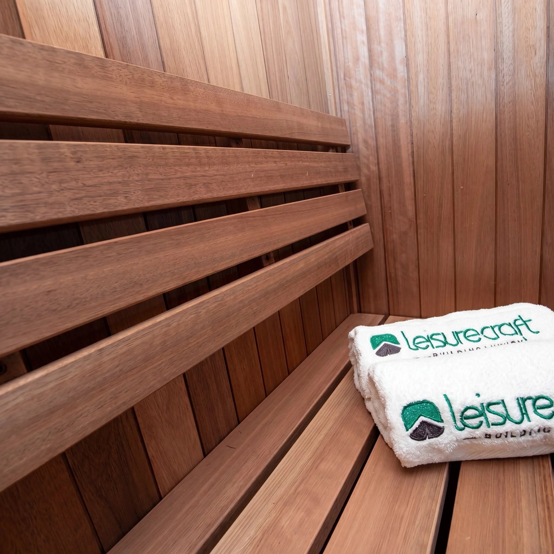 Bench slats and Thermo Grandis wall inside the CT Element Nook, with a folded LeisureCraft towel