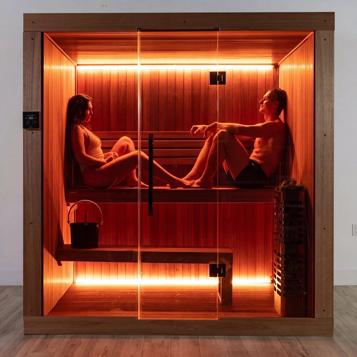 Two people seated on the benches inside the CT Element Studio, seen through the glass front